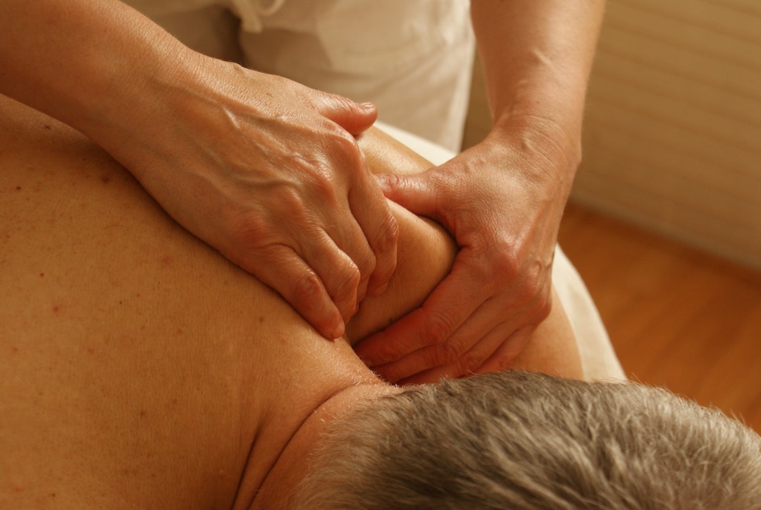 person getting a deep tissue massage in their home